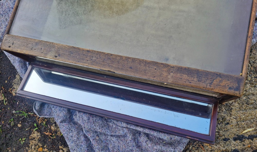 An antique dark oak tabletop display cabinet featuring a curved front glass pane and glazed top. View IV
