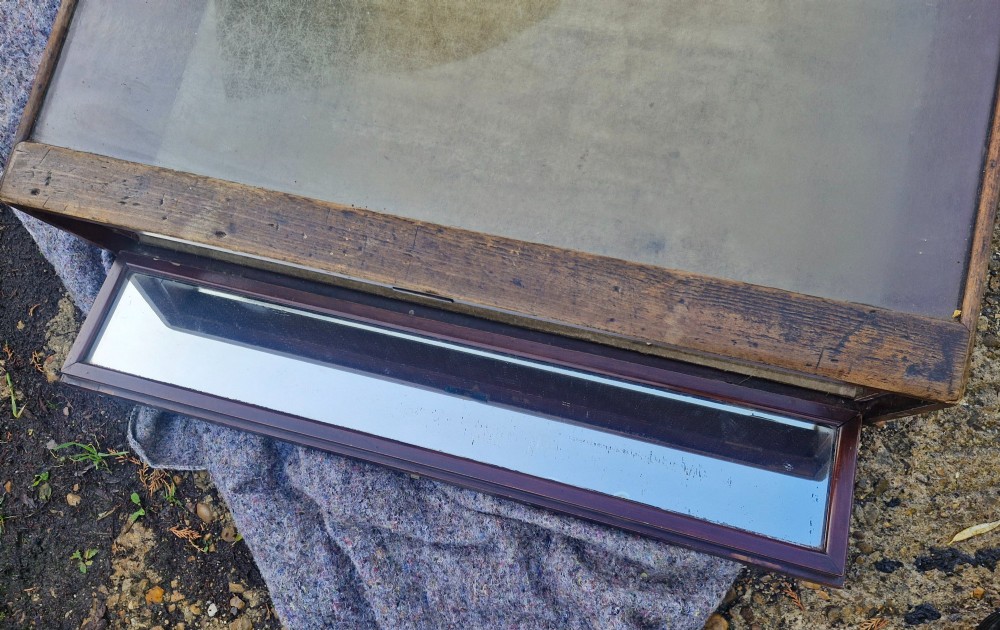 An antique dark oak tabletop display cabinet featuring a curved front glass pane and glazed top. View V
