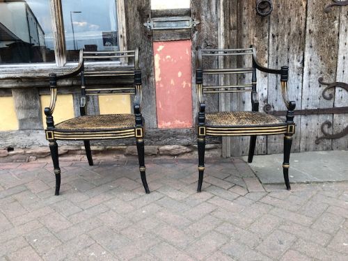 A Pair  Regency Ebonised Caned Chairs