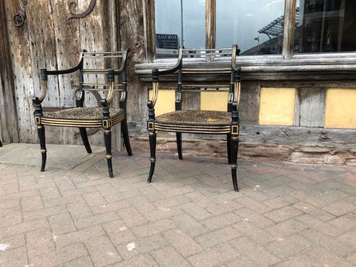 A Pair Regency Ebonised Caned Chairs