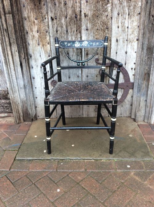 A Regency Ebonised and Decorated Rush Seated Chair