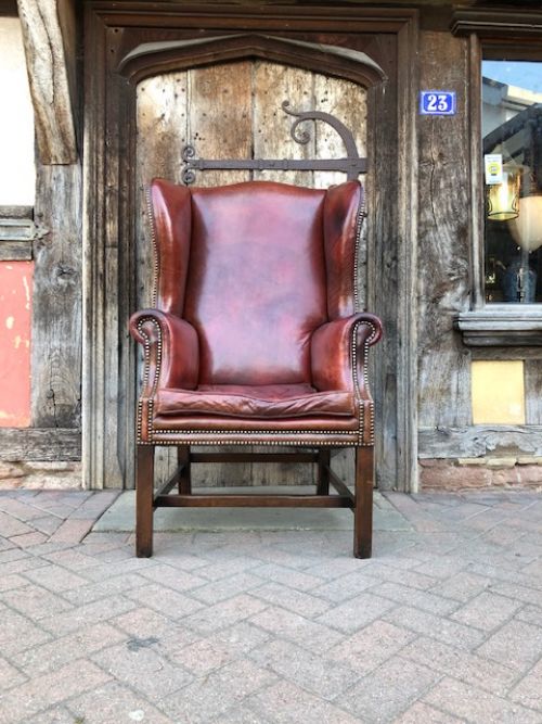 A 20th Century Mahogany Framed Red Leather Wing Armchair