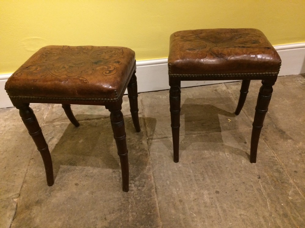 18thC Pair of mahogany sabre leg and embossed leather stools