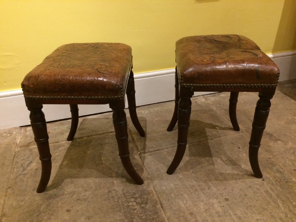 18thC Pair of mahogany sabre leg and embossed leather stools View V