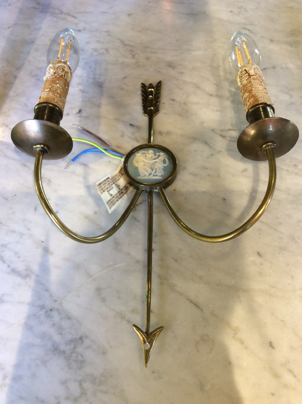 A pair of Edwardian brass twin-arm wall sconces featuring arrow motifs and circular blue jasperware medallions displaying white classical figures. View III