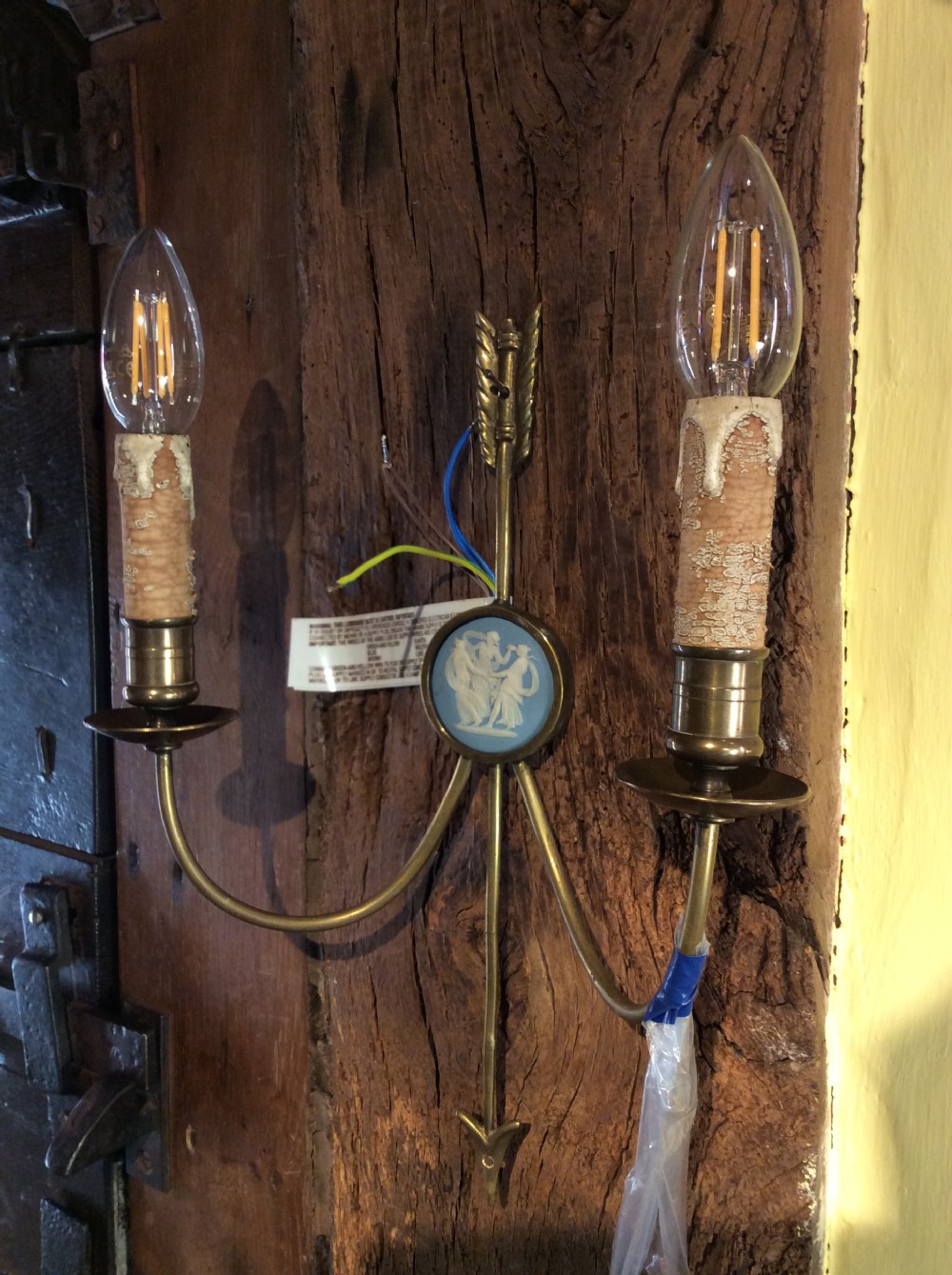 A pair of Edwardian brass twin-arm wall sconces featuring arrow motifs and circular blue jasperware medallions displaying white classical figures. View VII