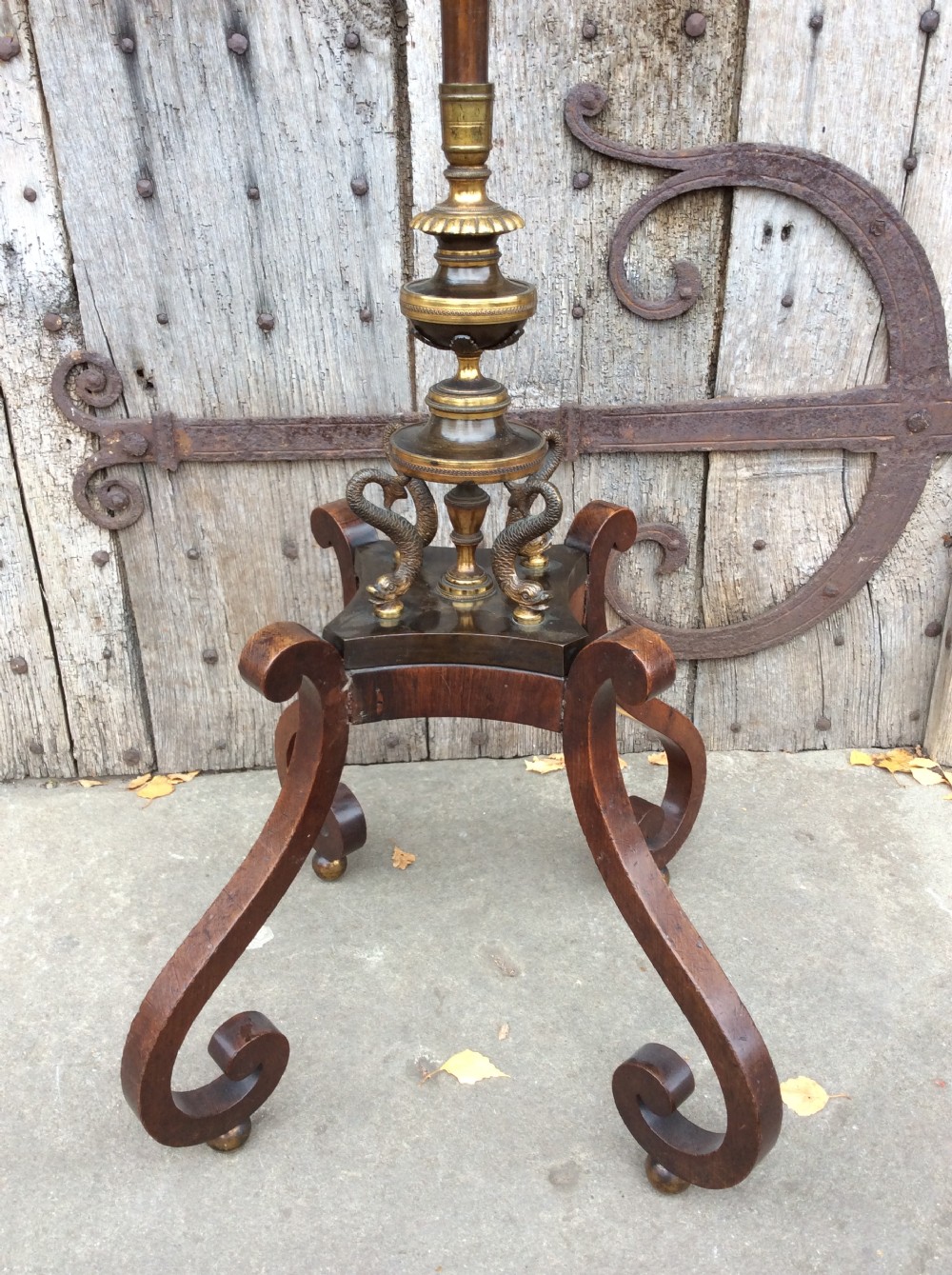 A 19th-century mahogany pole screen converted into a floor lamp featuring a slender turned shaft, gilt brass collars, and a scrolled tripod base. View III