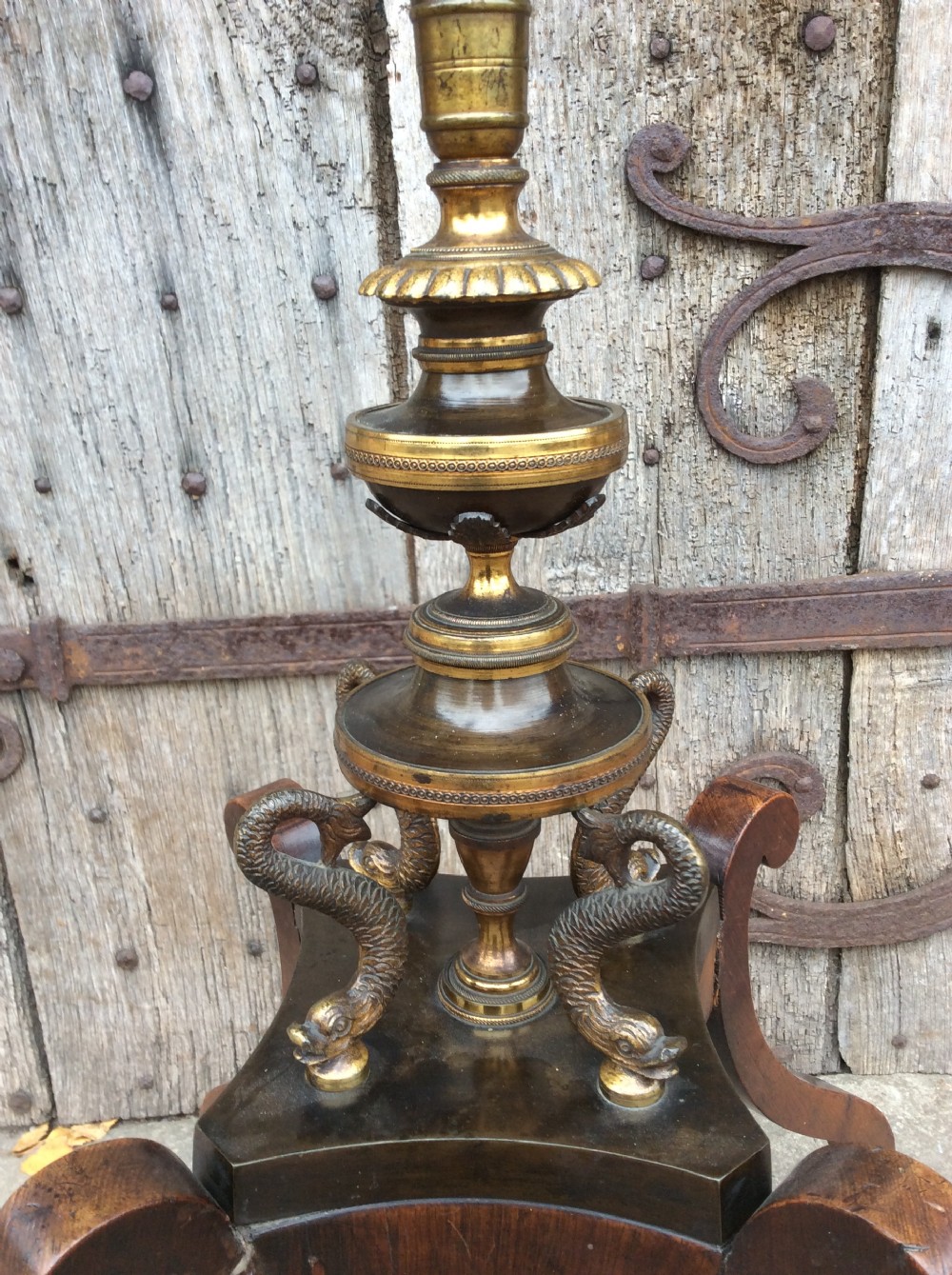 A 19th-century mahogany pole screen converted into a floor lamp featuring a slender turned shaft, gilt brass collars, and a scrolled tripod base. View V