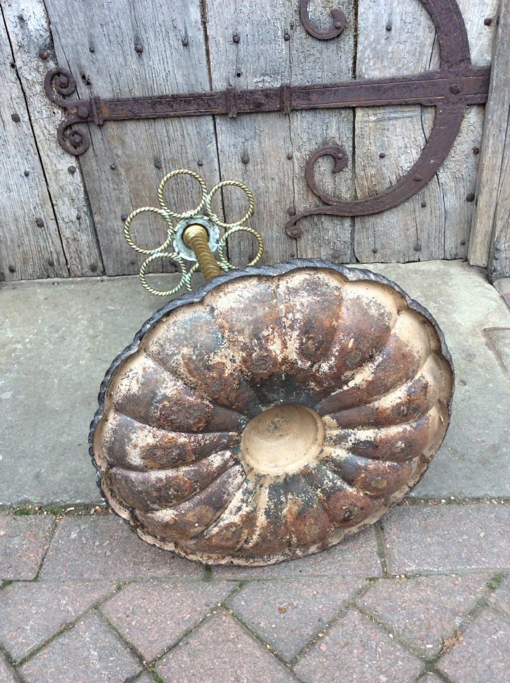 A Victorian brass and cast iron umbrella stand featuring a barley twist column, six circular divisions, and a scalloped drip tray base. View VII