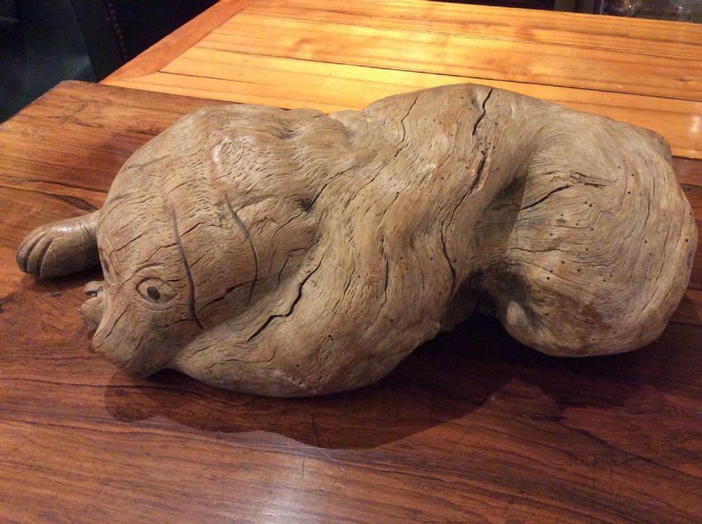 Folk art wood carving of a recumbent dog c.1890