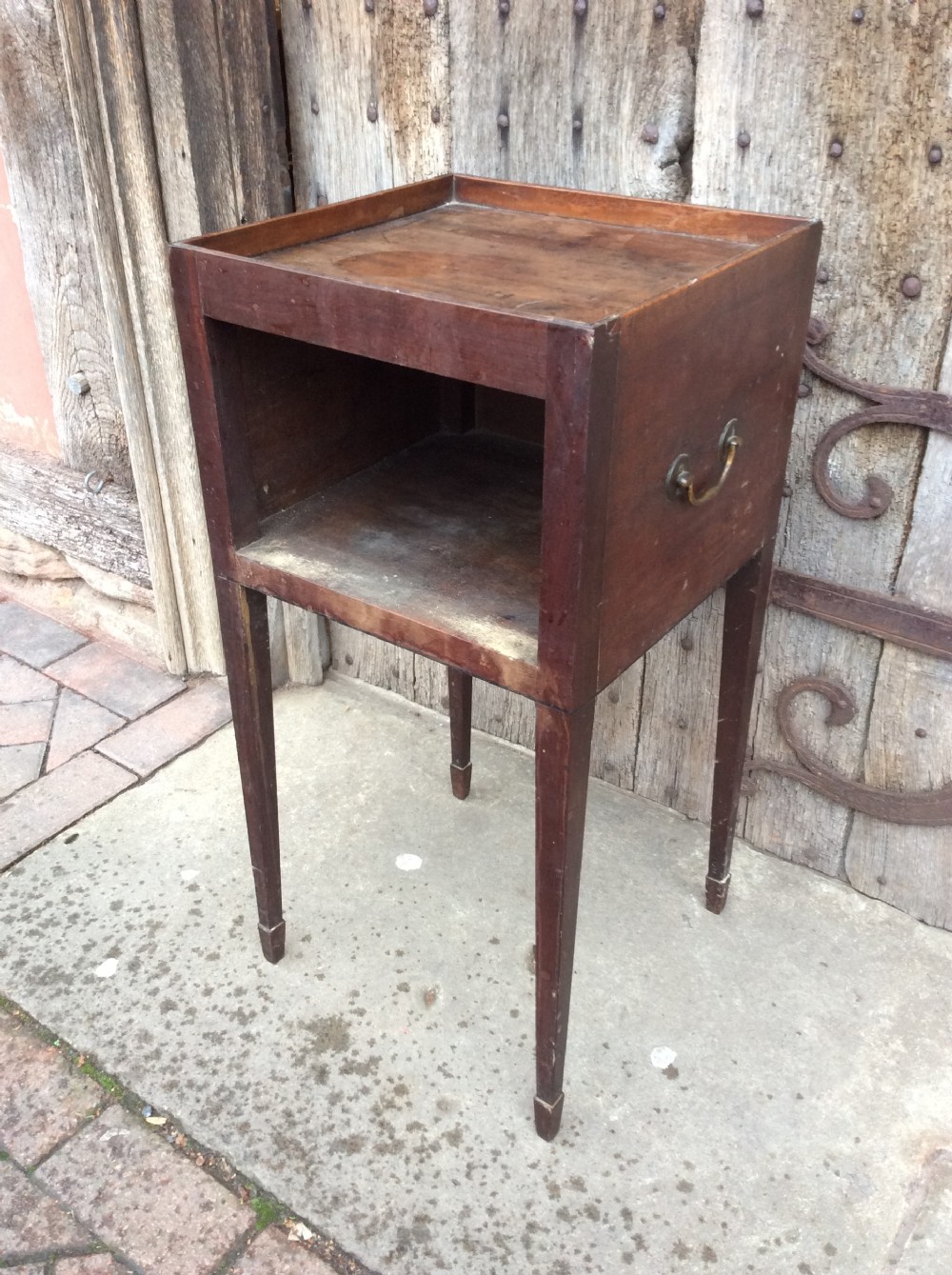 An 18th-century Georgian mahogany book table featuring a tray top gallery, an open compartment, and slender square tapered legs. View II