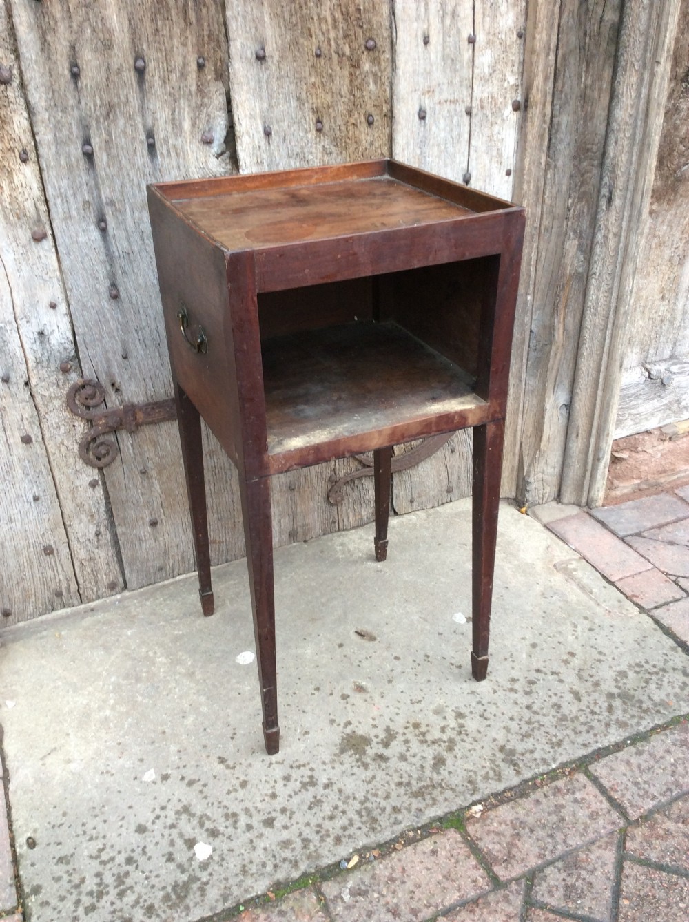 An 18th-century Georgian mahogany book table featuring a tray top gallery, an open compartment, and slender square tapered legs. View III
