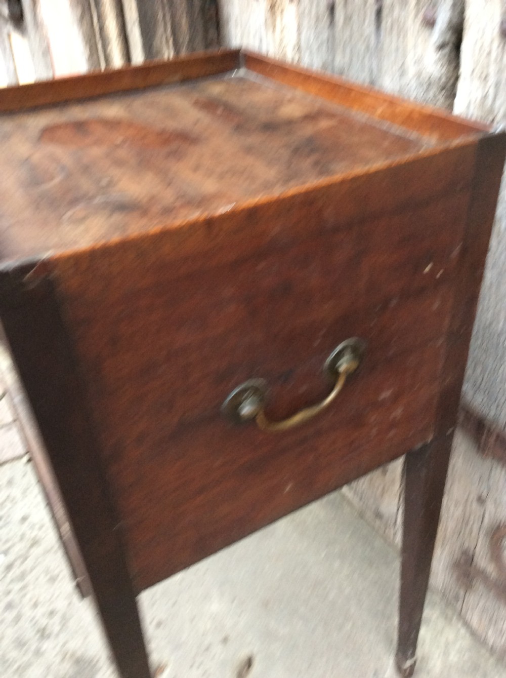 An 18th-century Georgian mahogany book table featuring a tray top gallery, an open compartment, and slender square tapered legs. View VI