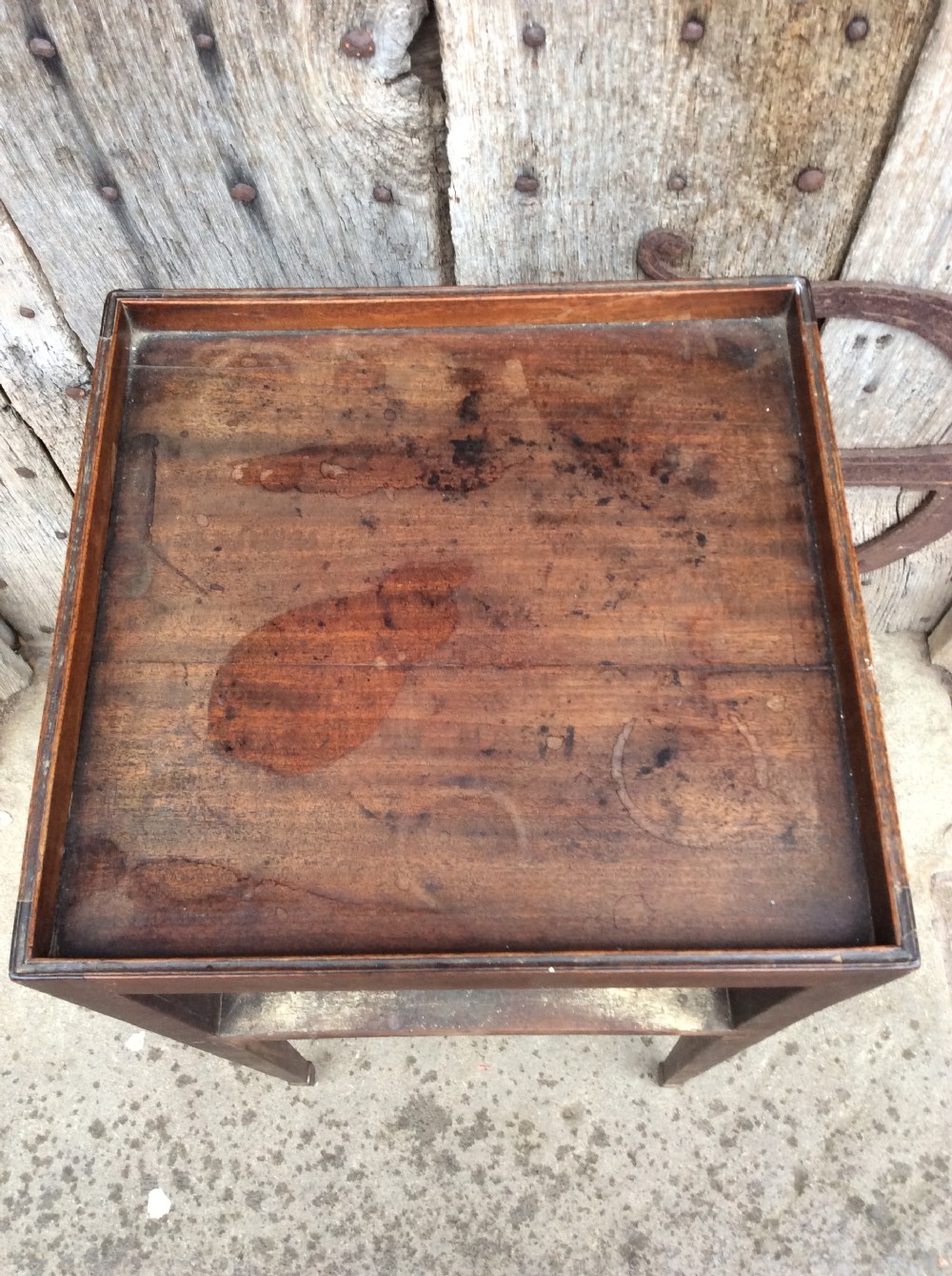 An 18th-century Georgian mahogany book table featuring a tray top gallery, an open compartment, and slender square tapered legs. View VII