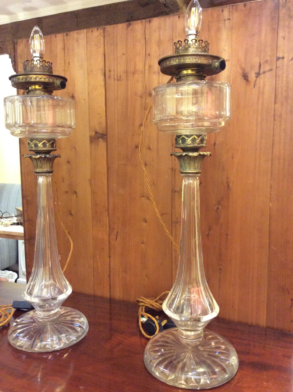 A pair of tall 19th-century clear cut glass table lamps featuring fluted column stems and brass gallery fittings. View IX