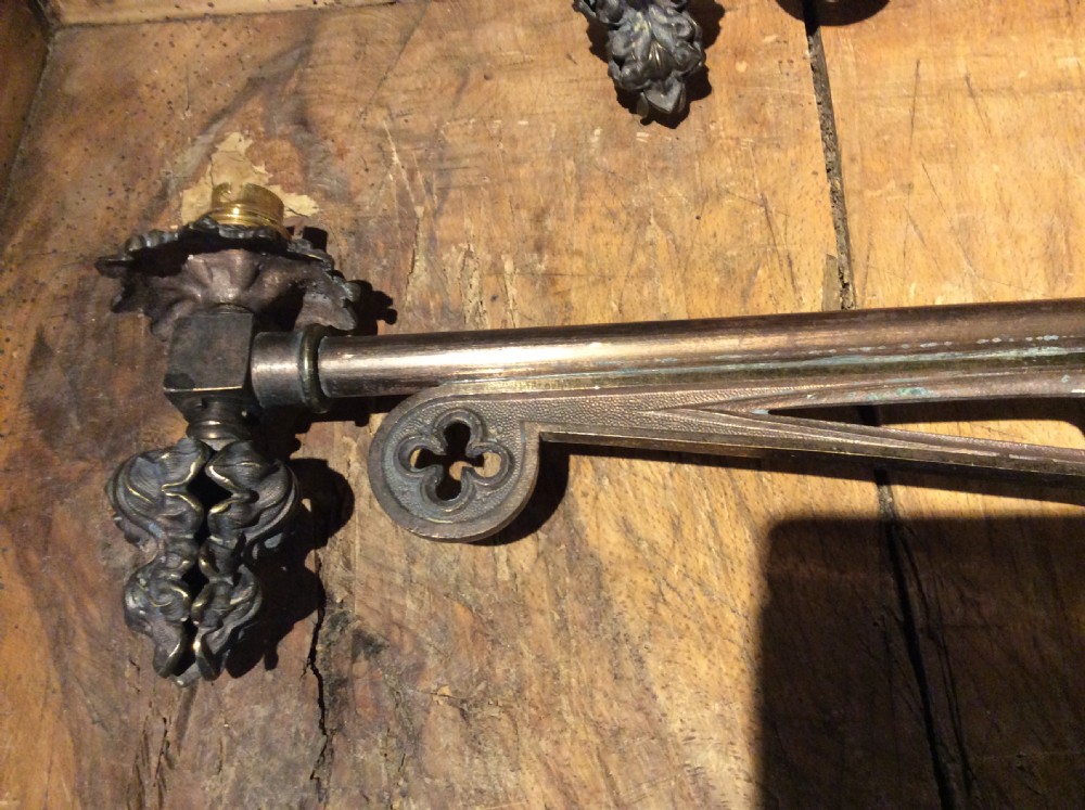 A pair of patinated dark brass Victorian Gothic wall light brackets featuring openwork tracery with trefoil motifs and detailed cast collars. View III
