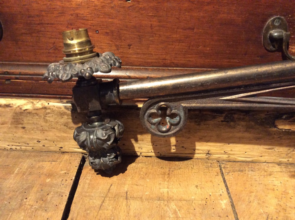 A pair of patinated dark brass Victorian Gothic wall light brackets featuring openwork tracery with trefoil motifs and detailed cast collars. View V