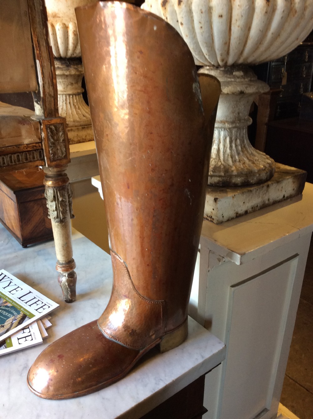 A large quirky copper and brass boot