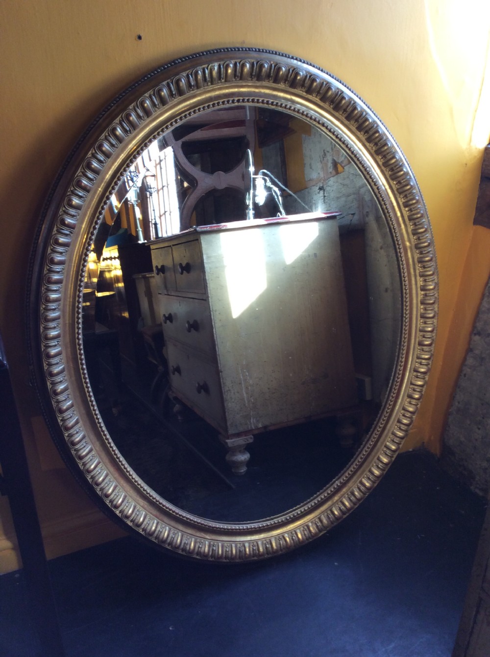 19thC oval gilded mirror