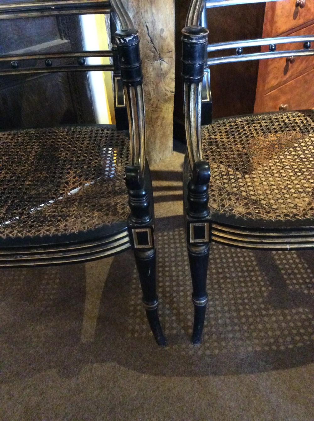 A pair  Regency ebonised caned chairs View V