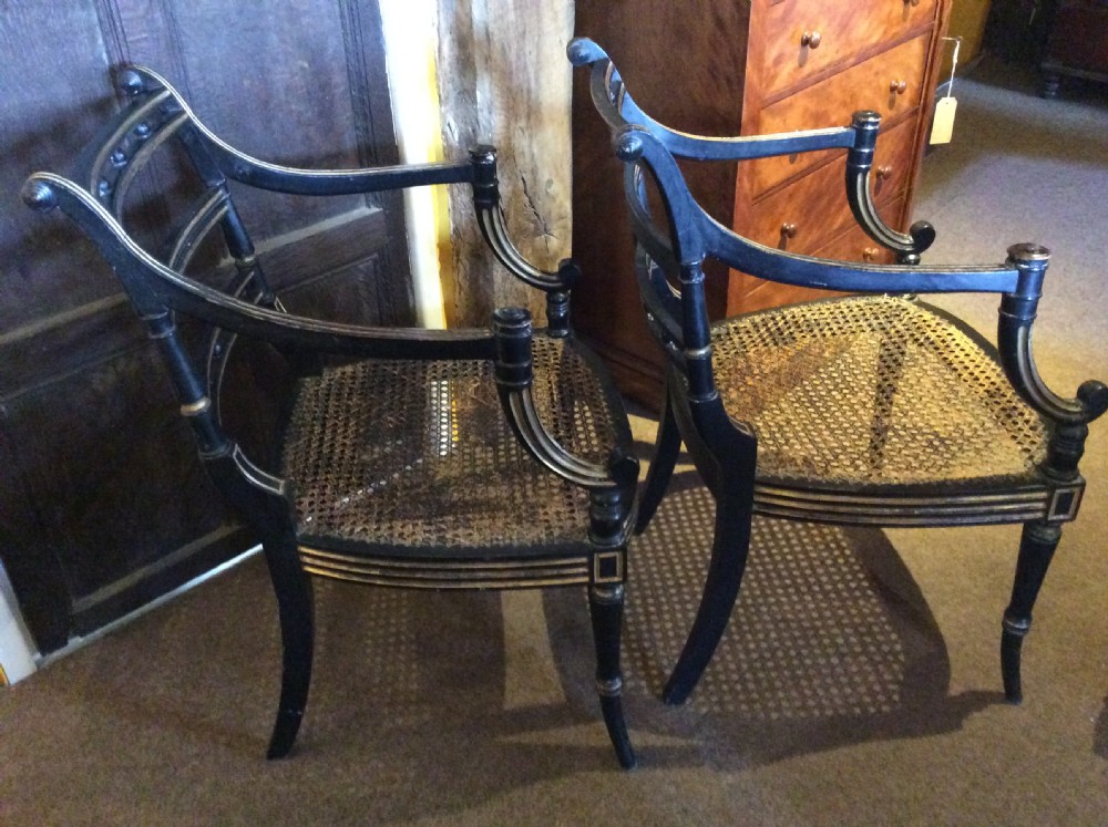 A pair  Regency ebonised caned chairs View VI