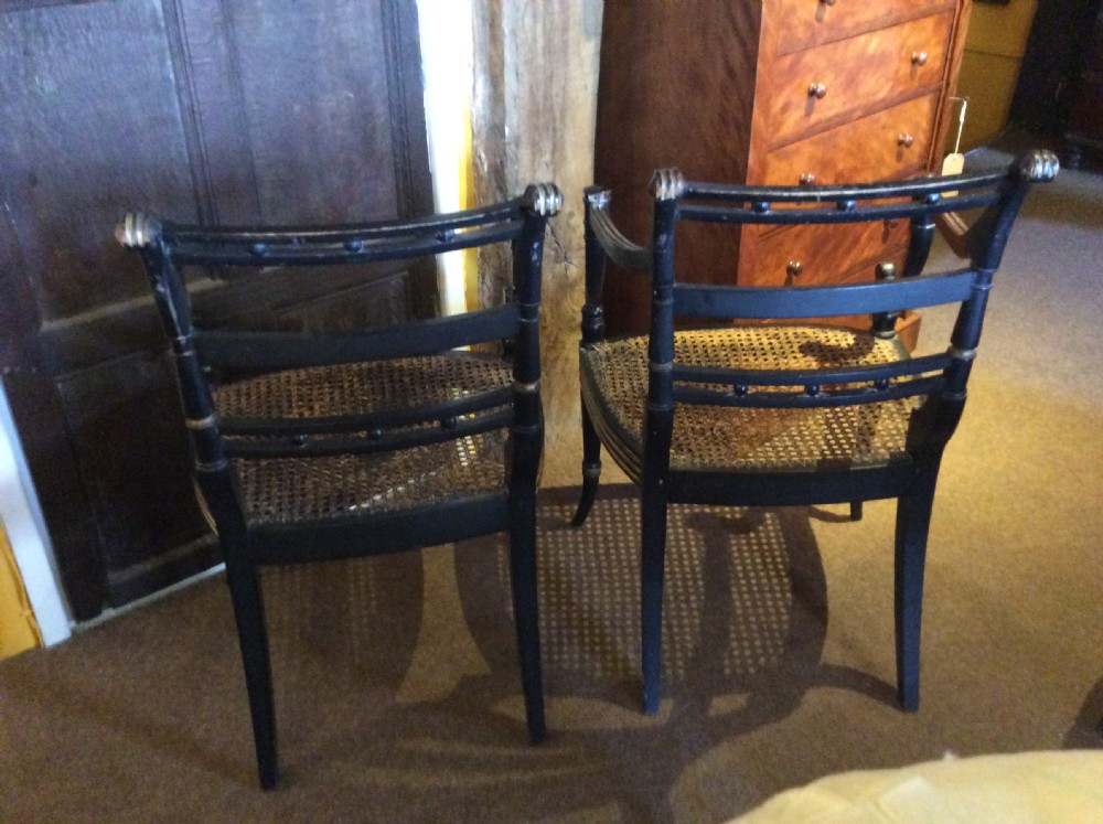 A pair  Regency ebonised caned chairs View VII