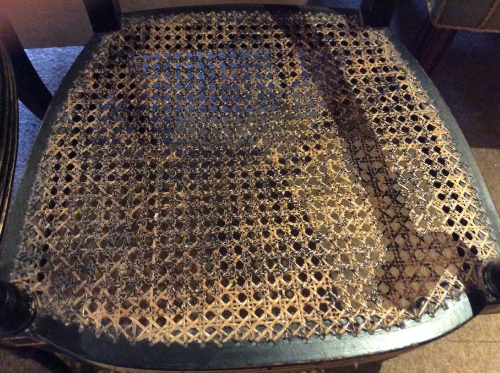 A pair  Regency ebonised caned chairs View IX