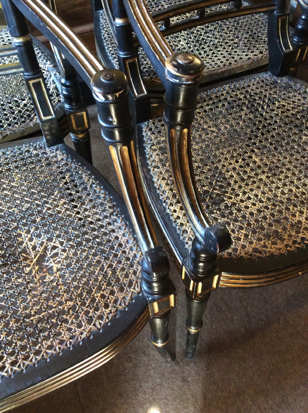 A pair  Regency ebonised caned chairs View X