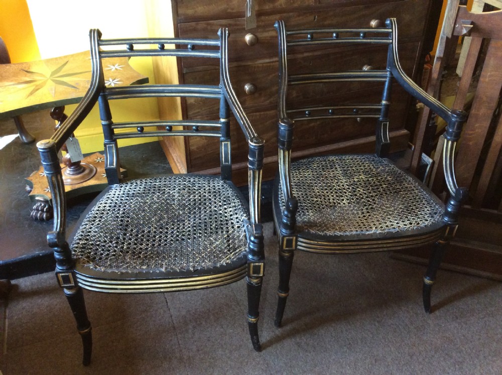 A pair Regency Ebonised caned chairs View IV
