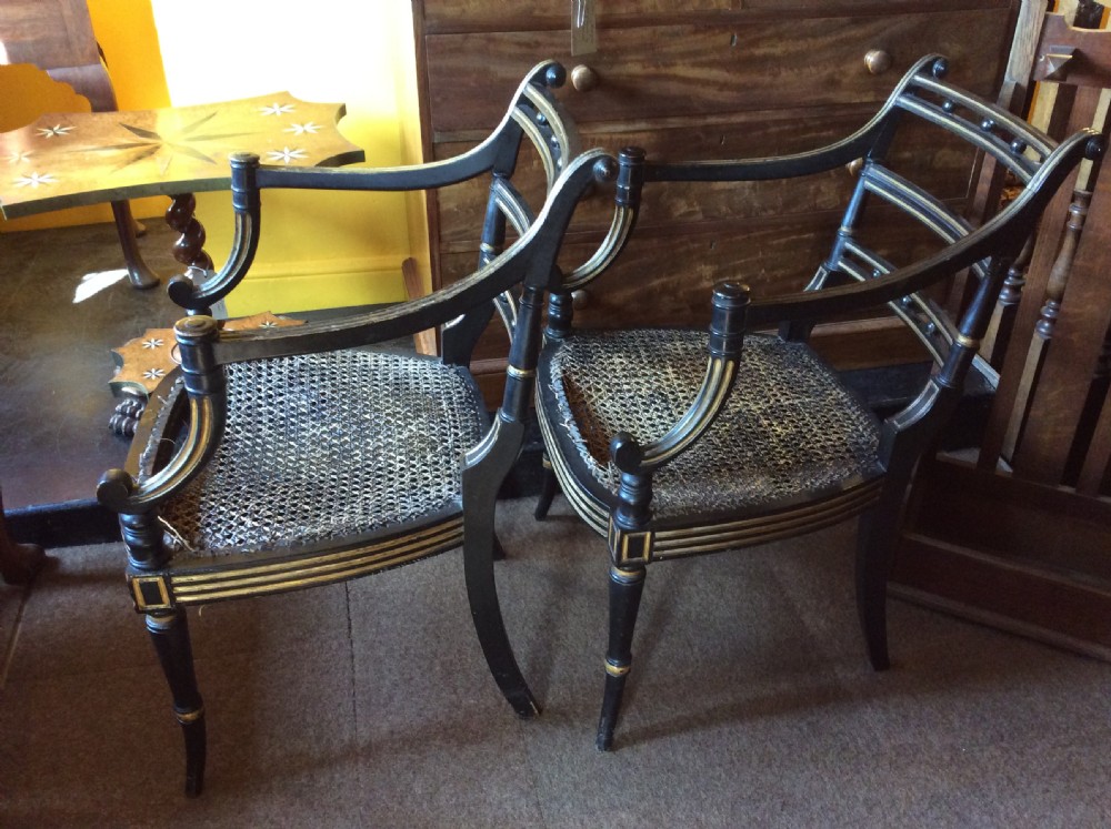 A pair Regency Ebonised caned chairs View VI