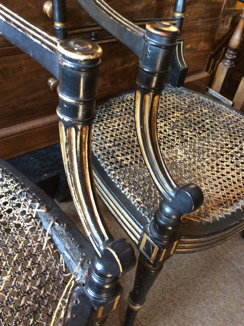 A pair Regency Ebonised caned chairs View IX
