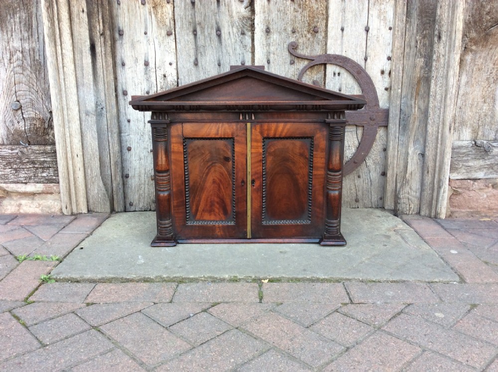 An Early 19thC architectural mahogany wall cabinet