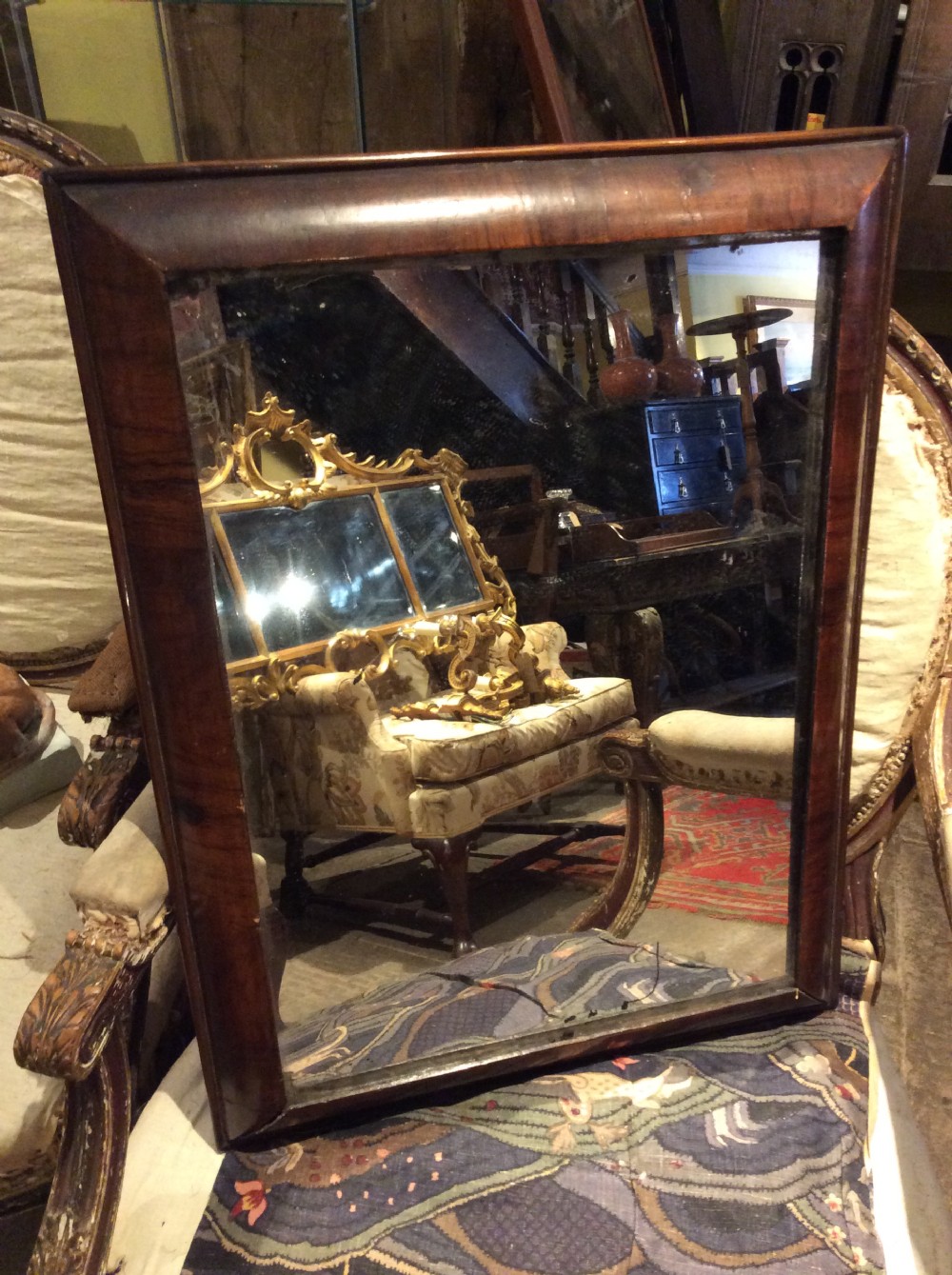 An 18thC Verneered walnut cushion mirror