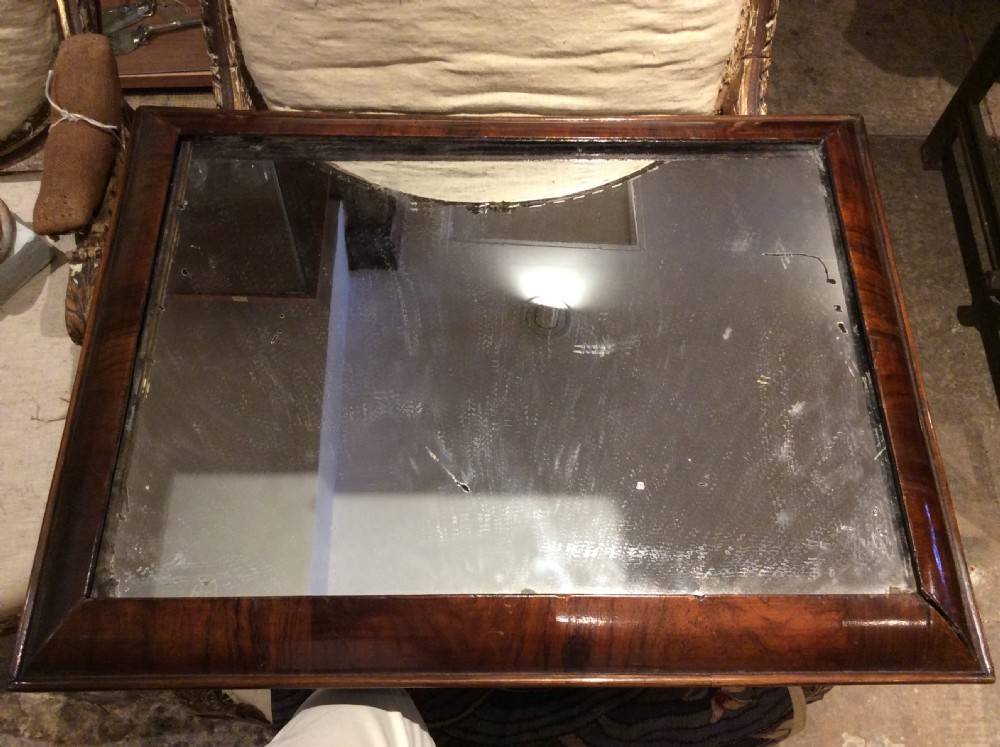 An 18thC Verneered walnut cushion mirror View V