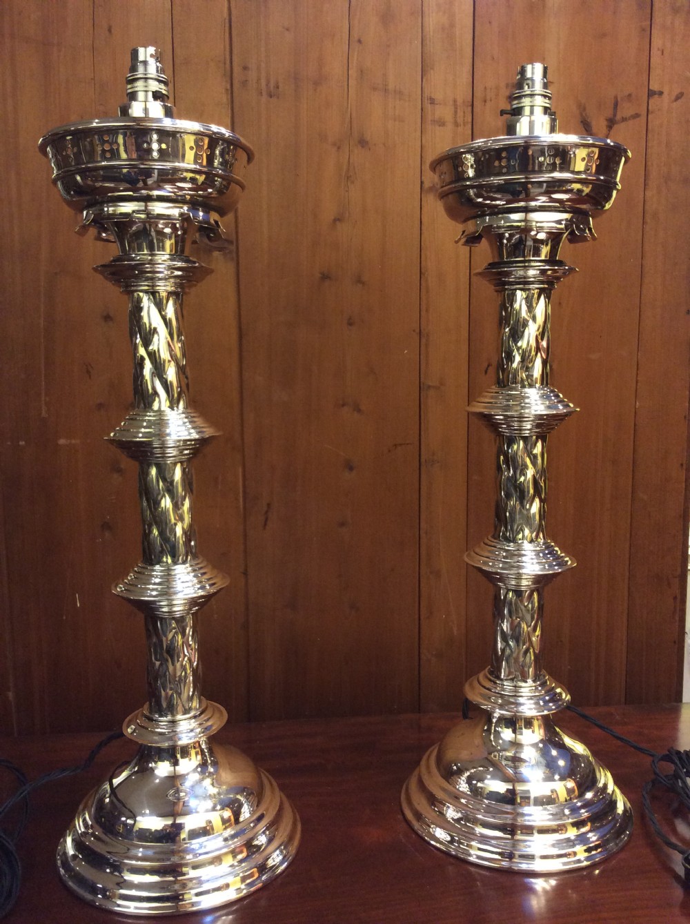A pair of Edwardian silver plated converted Gothic candlesticks