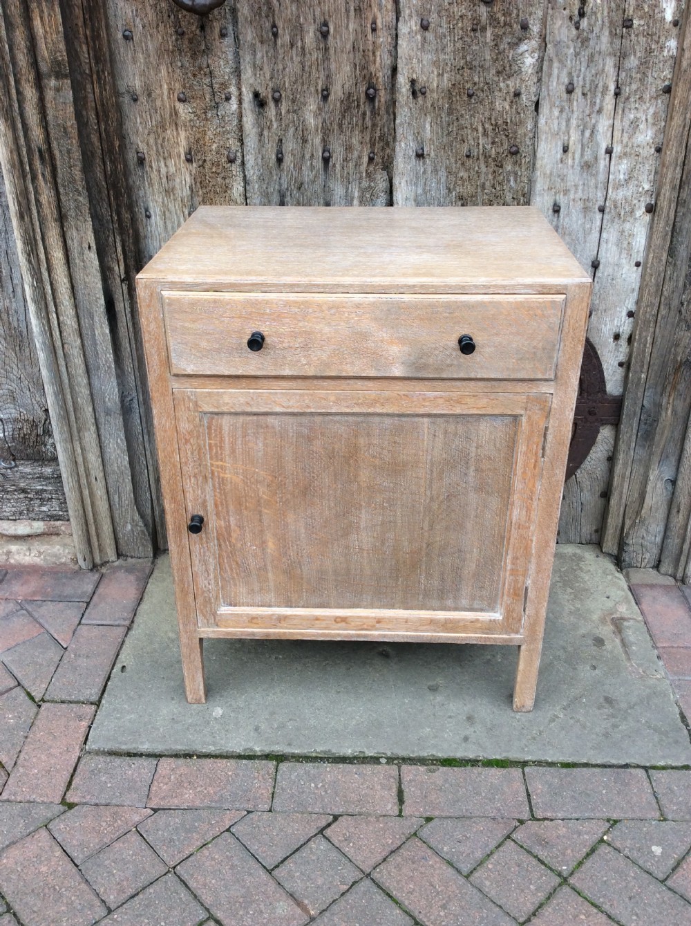A 20thC light oak Heals cupboard