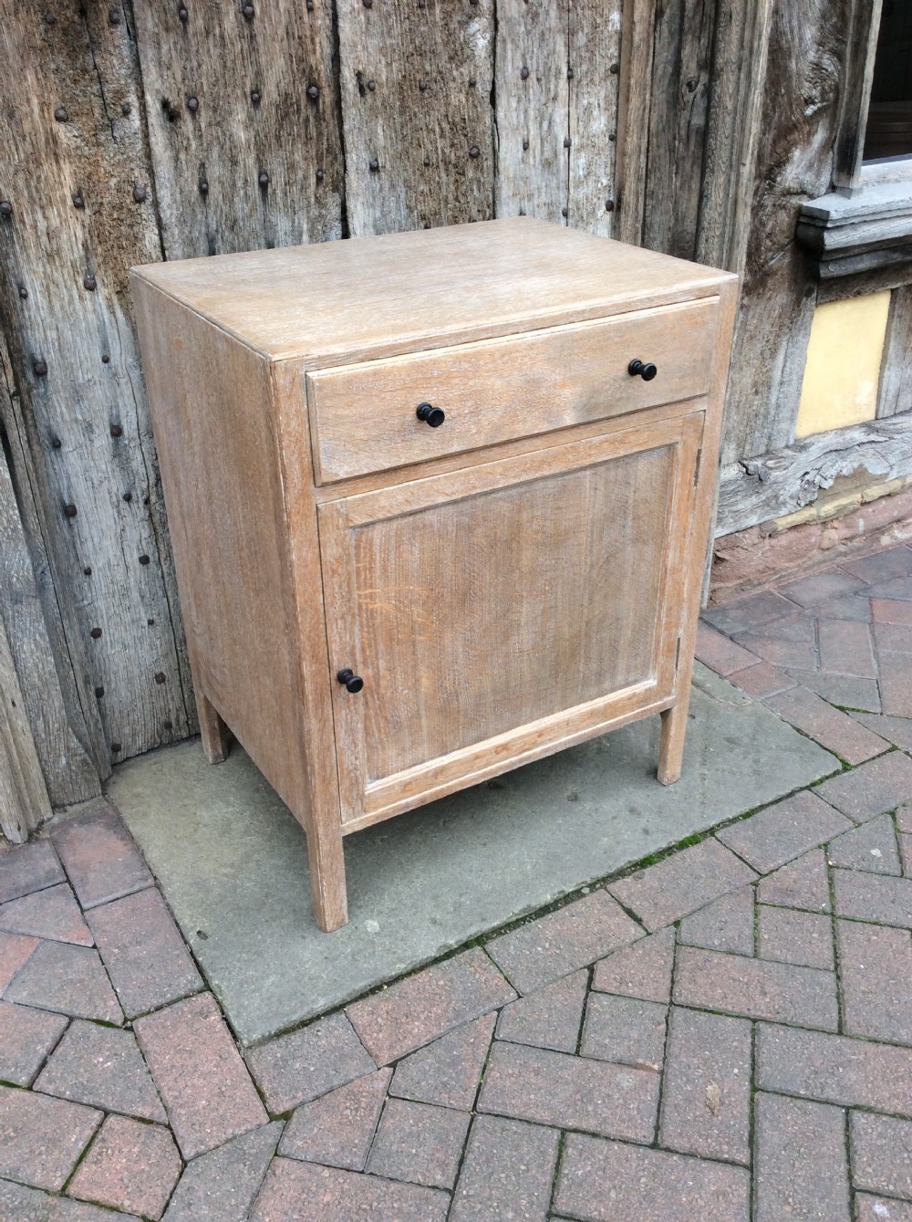 A 20thC light oak Heals cupboard View III
