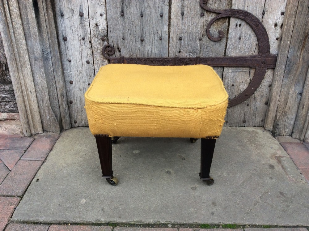 An Edwardian mahogany footstool