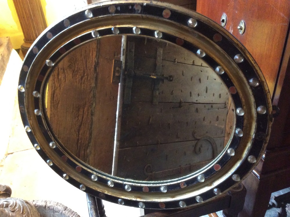 A 19thC oval Irish mirror with ebonised & gilded frame View IV