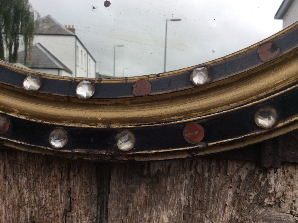 A 19thC oval Irish mirror with ebonised & gilded frame View VI