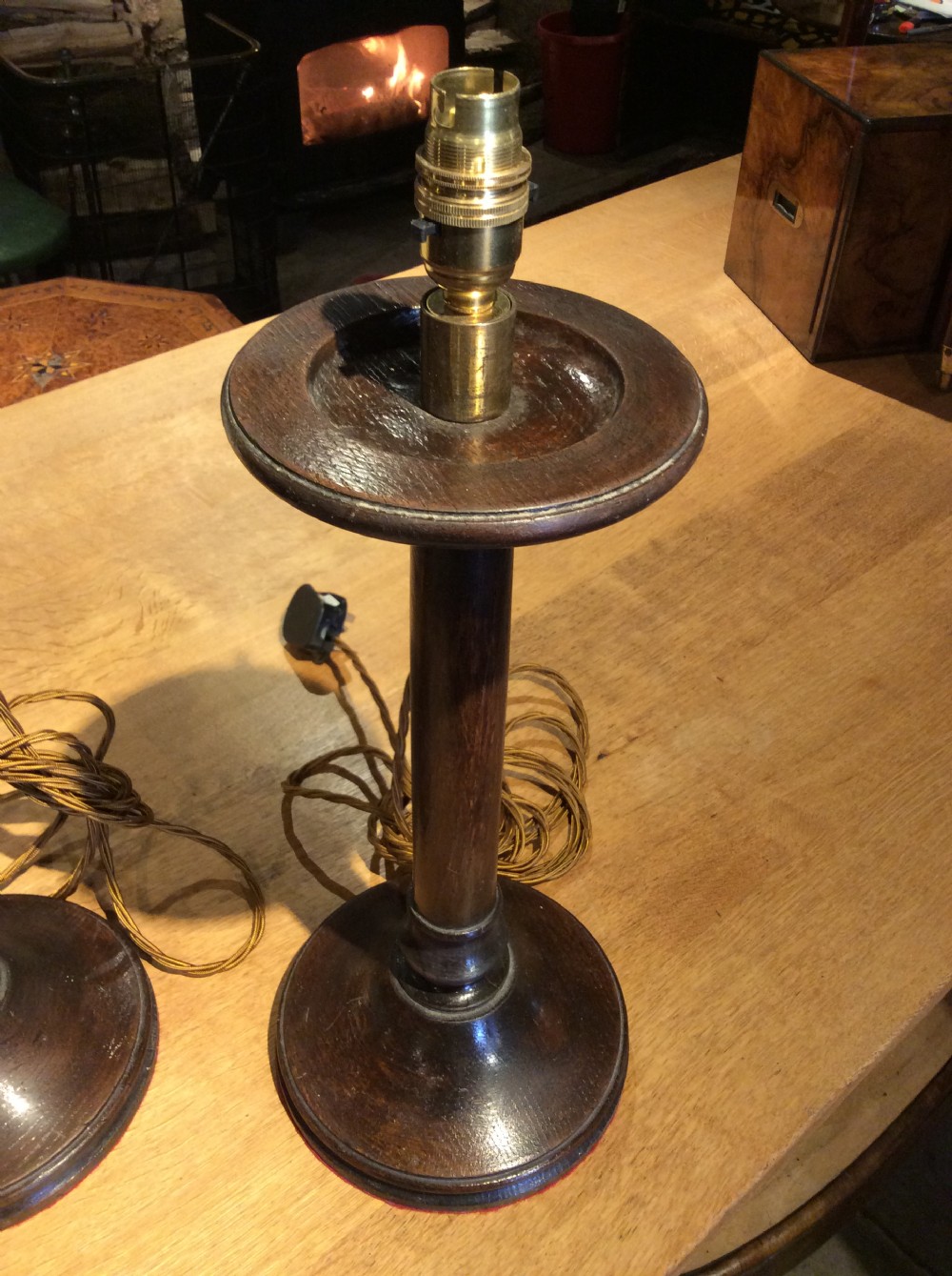A pair of Edwardian candlestick oak lamps View II