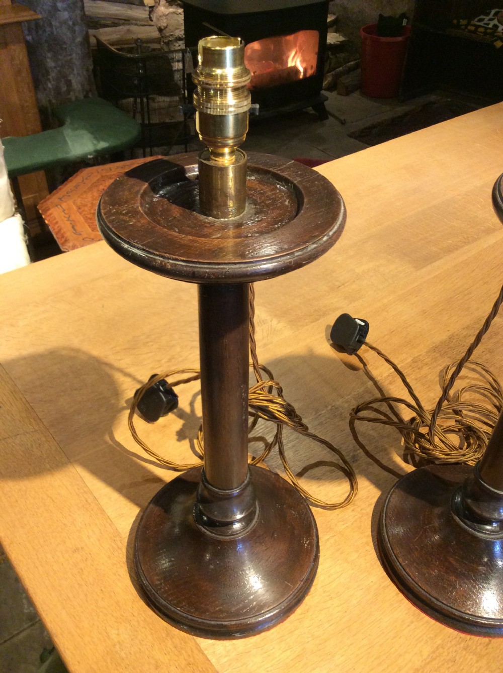 A pair of Edwardian candlestick oak lamps View III