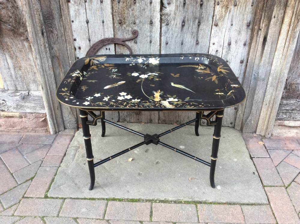 A 19thC papier mâché tray standing on later stand