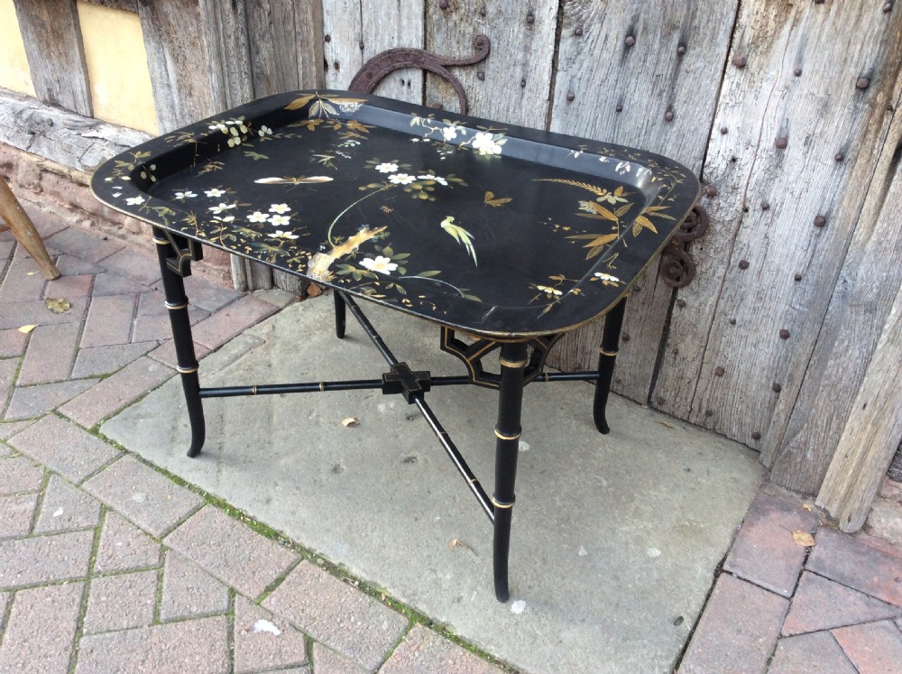 A 19thC papier mâché tray standing on later stand View II