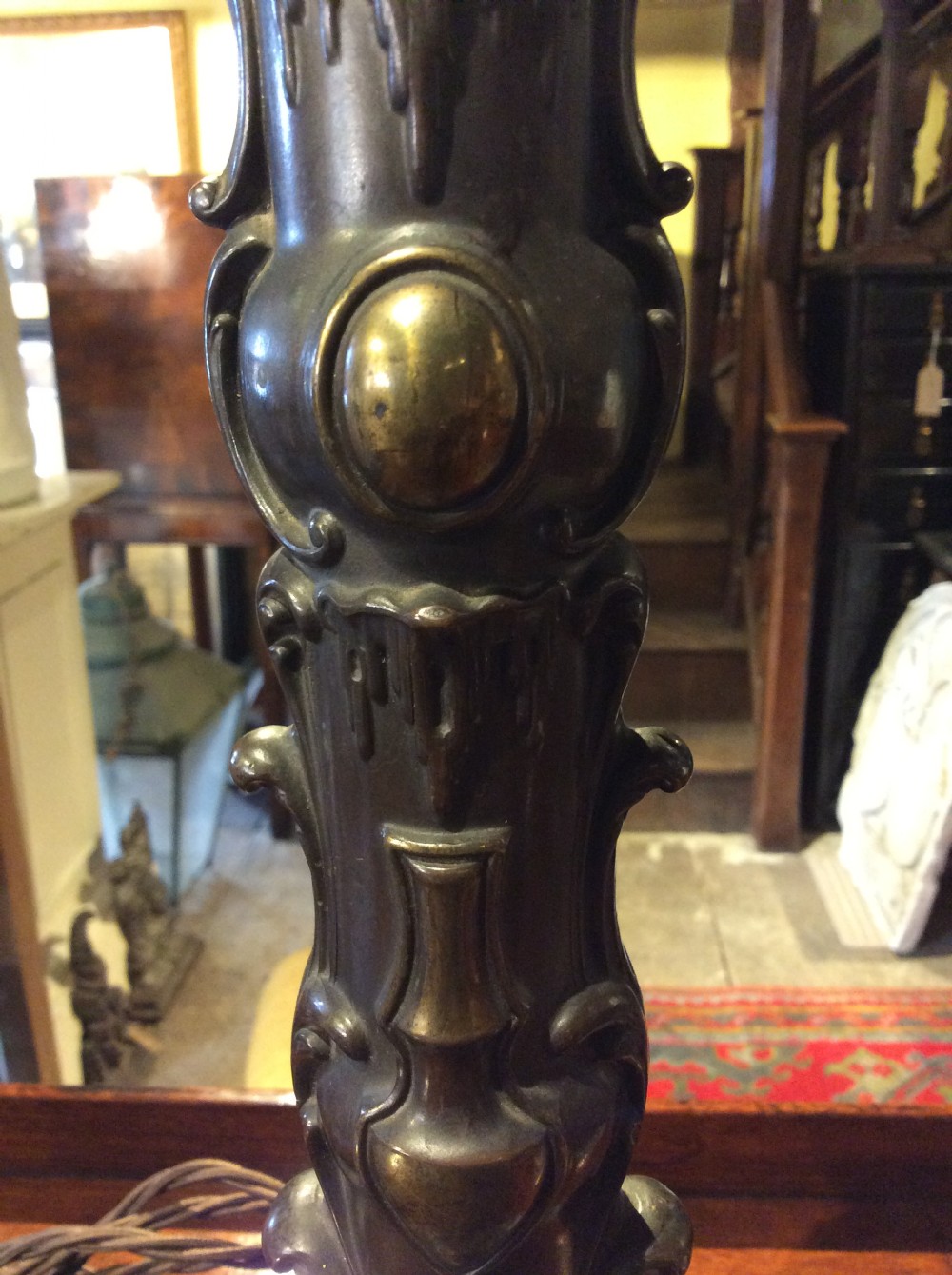 A pair of nineteenth-century repousse brass table lamps featuring ornate scrolling foliage stems on hexagonal bases. View III
