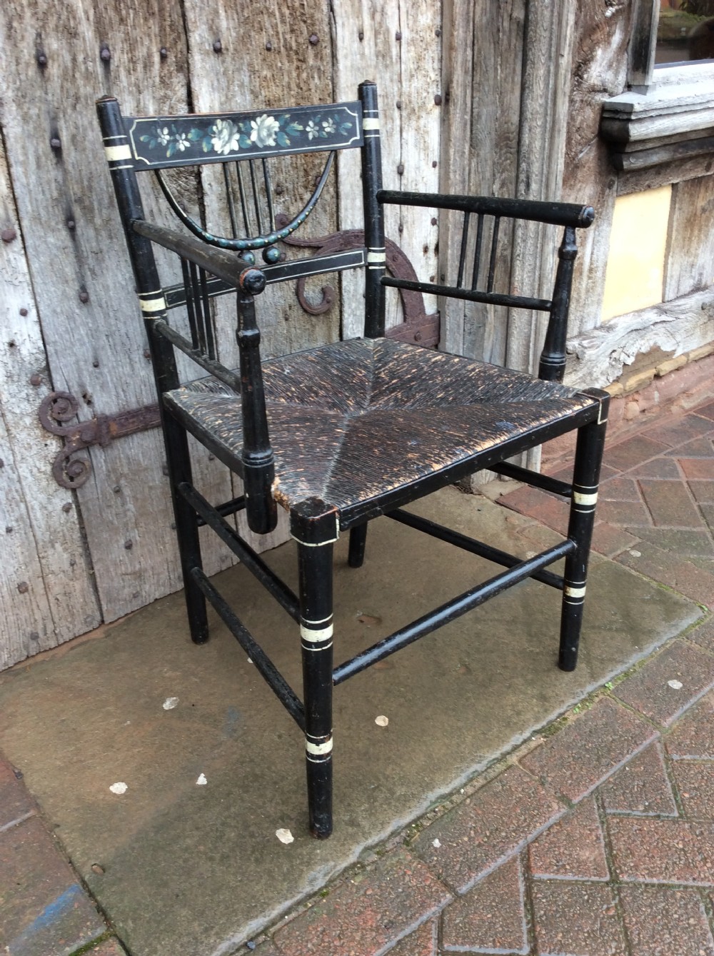 A Regency ebonised and decorated rush seated chair View III