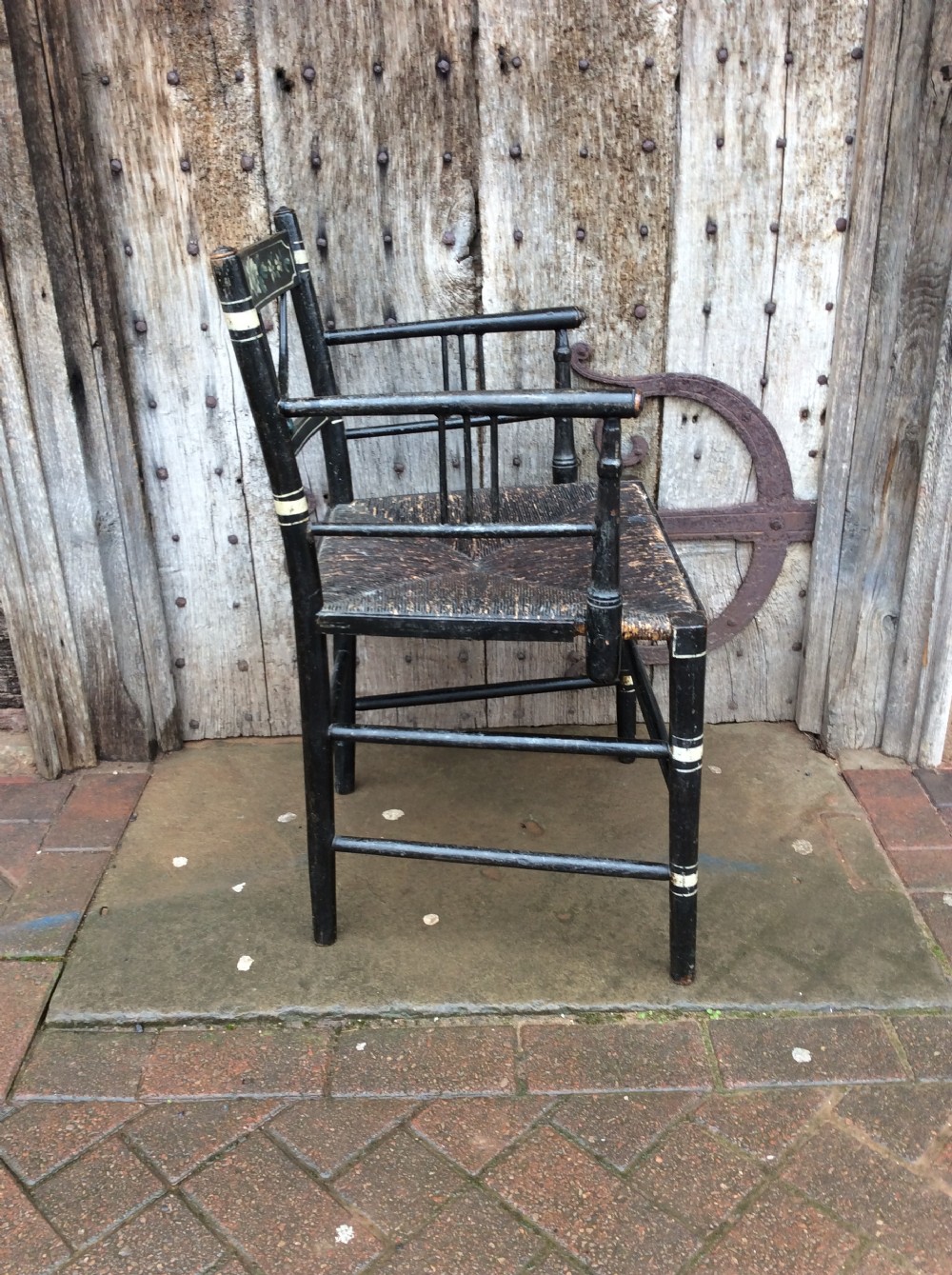 A Regency ebonised and decorated rush seated chair View IV