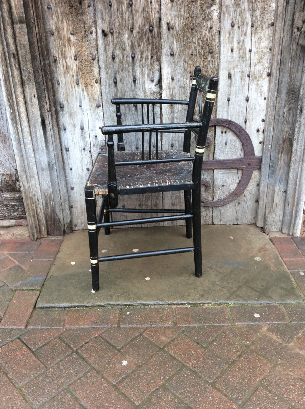 A Regency ebonised and decorated rush seated chair View VI