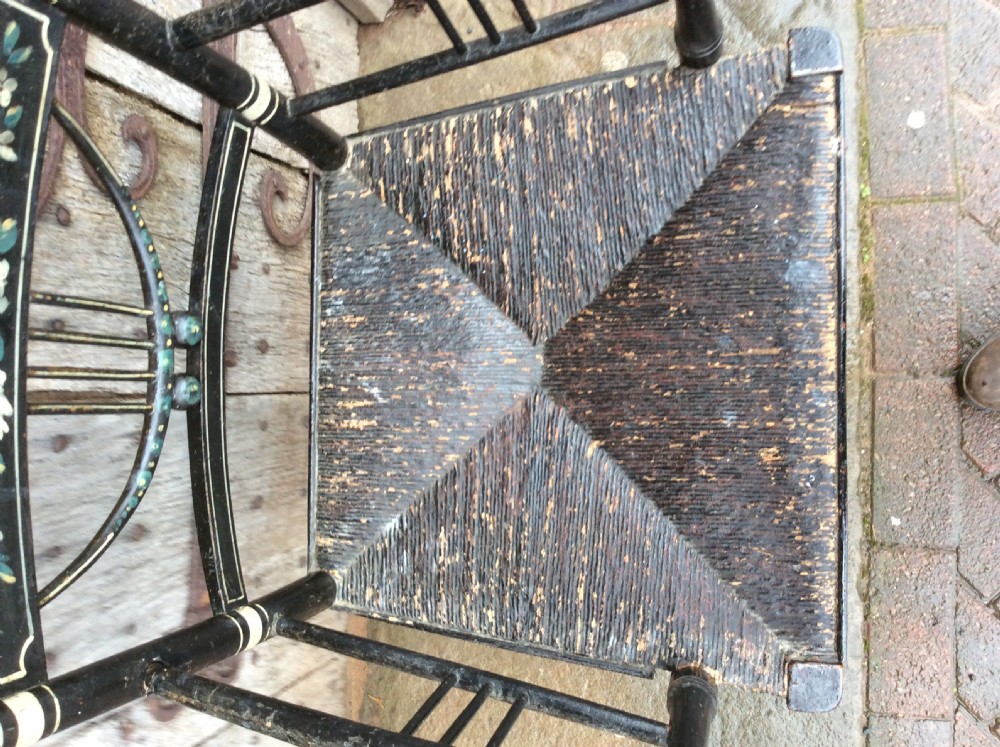 A Regency ebonised and decorated rush seated chair View VIII
