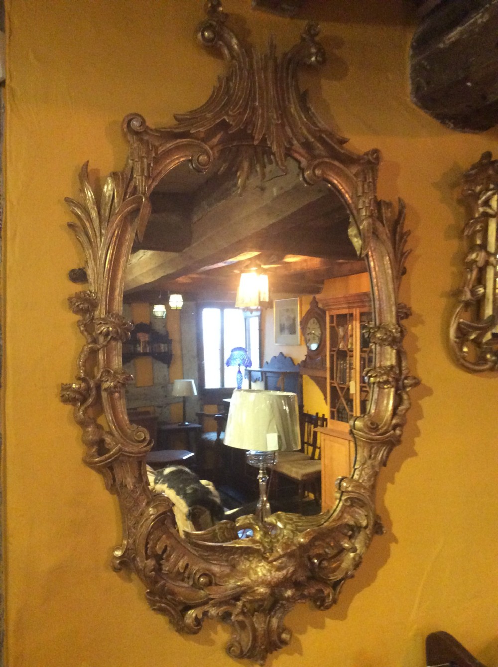 An 18thC carved and gilded oval shaped mirror  View XI